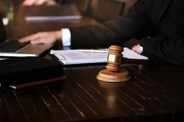 Legal counsel presents to the client a signed contract with gavel and legal law. justice and lawyer concept.