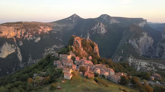 Slowly flying towards the French mountain village Rougon at dusk