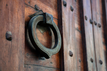vintage iron knocker on the old door in Italy