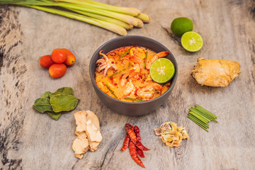 Prawn and lemon grass soup with mushrooms,Tom Yam Kung ,thai food in wooden background, top view