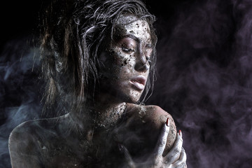 fashion portrait of a dark-skinned girl with silver foil make-up. Beauty face.