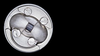 close up, macro shot, top view of single micro coil with japanese organic cotton wick in high end rebuildable dripping atomizer for flavour chaser isolated on black background, vape gear
