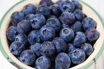 fresh juicy blueberries in a bowl, closeup