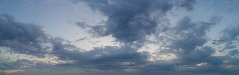 Panoramic view of evening sky with clouds, the sky at twilight.