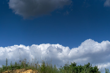 Fototapeta premium Dark storm clouds against blue sky. Sky before the storm