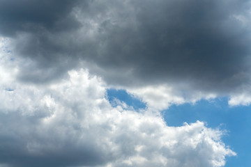 Fototapeta premium Dark storm clouds against blue sky. Sky before the storm