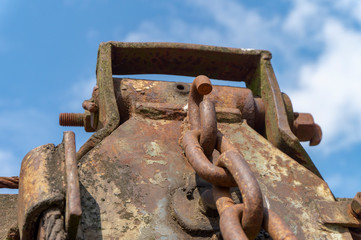 Close up on an old rusted chain on a machine