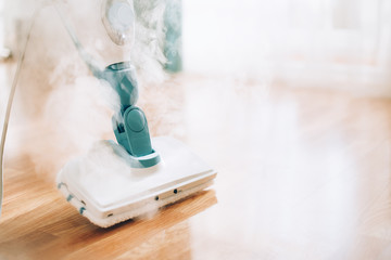 Steam cleaner mop cleaining floor. Banner with copy space. Cleaning service concept
