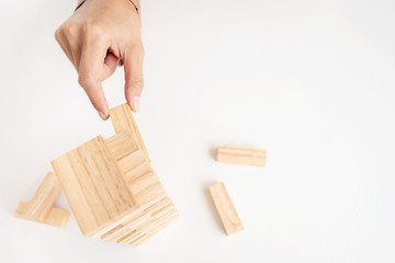 Business executive holding wooden block, Risk and strategy in planing.
