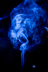 Blue toxic fumes movement on a black background.