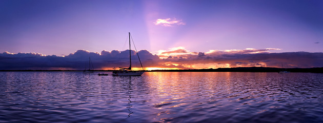 Blue, mauve coloured stratocumulus cloudy nautical coastal Sunset Seascape.