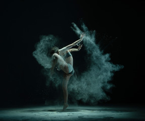 Fototapeta na wymiar Anonymous dancer throwing sand and lifting leg
