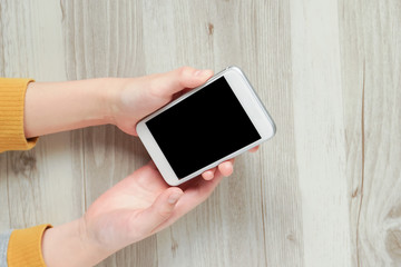 Female hands using a smartphone.  スマートフォンを使う女性の手