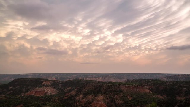 Time lapse over Palo Duro Canyon in Texas viewing mammatus clouds as they appear during colorful sunset.