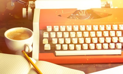 Old typewriter with paper and coffee  on background