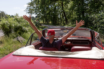 Senior Man in the red Ford Mustang Cabriolet