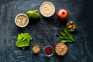 selection of healthy superfood on the chalkboard surface with fruit cereals and herb