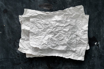 flat lay crumpled white paper sheet isolated on the table, background texture and copy spaces