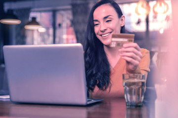 Positive joyful woman sitting in front of the laptop