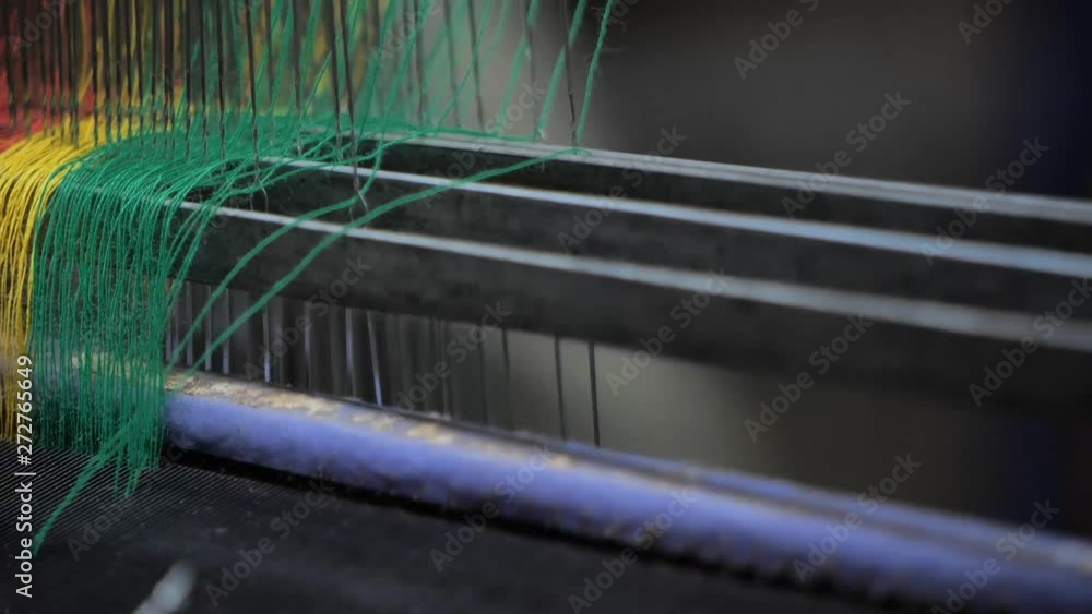 Poster close up workers weave thread using a handloom