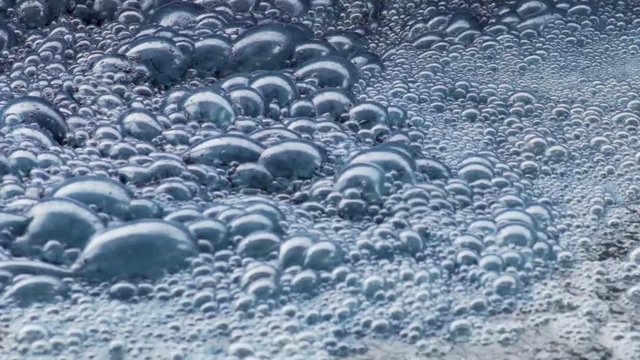 Indigo Blue Dye Bubbles Form In The Water Dying Process Of Denim Textiles.