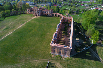 Above the ruins of the ancient palace of the princes Sapeg on a sunny April day (aerial photography). Ruzhany, Belarus