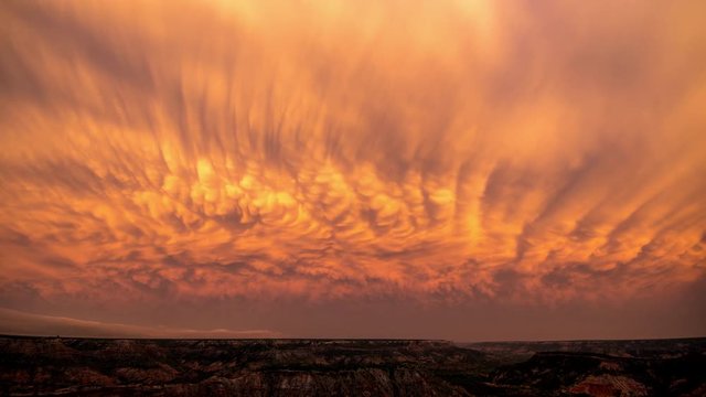 Sunset timelapse of mammatus clouds changing color over Palo Duro Canyon in Texas after a storm.