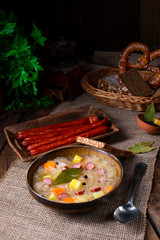 rustic sauerkraut soup with bacon and sausage