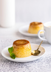 Creme caramel dessert or flan  decorated  with whipped cream and mint  . Sweet moment vertical background.