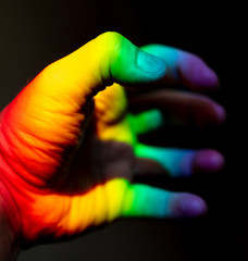 Man's hand in rainbow color