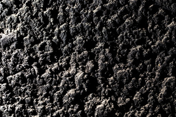 Black wall of sand and concrete as an abstract background