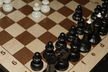 Chessboard under black chessmen as a skill backdrop