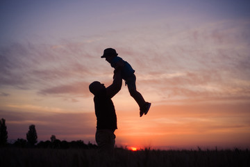 man throws up boy field in the evening