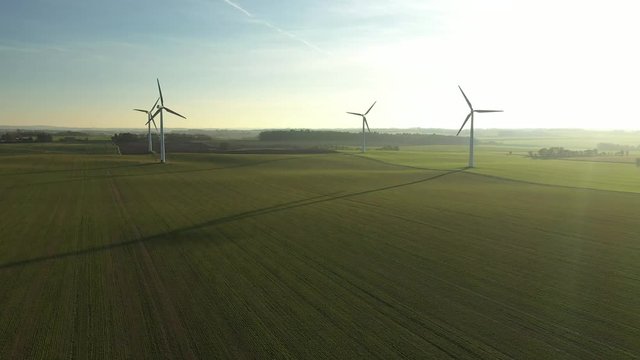 Aerial golden hour windmills in Danish landscape