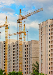 Fototapeta na wymiar Construction site with cranes, urban background