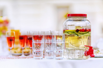 Glassware with colorful drinks on a white table