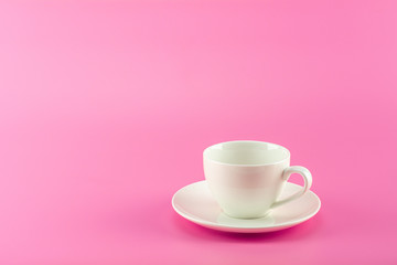 white ceramic coffee in pink background.