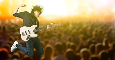 Portrait of a Musician Jumping while Playing an Electric Bass