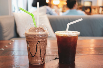 Smoothie coco and americano coffee on wooden table