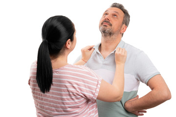 Woman arranging collar of man