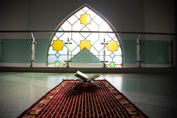 Quran in the mosque - open for prayers The black background of the Muslims around the world placed...
