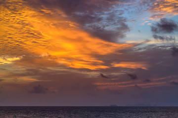 The waves in the sea during the twilight, the colorful sky, looking from the top view.