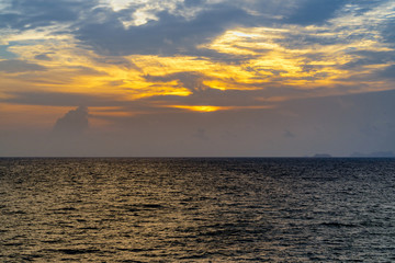 Blue ocean waves to the beach on the island sunset, looking from top view.