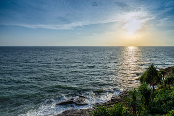 Blue ocean waves to the beach on the island sunset, looking from top view.
