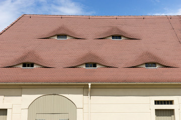 Semi-circular windows in the roof in a country cottage
