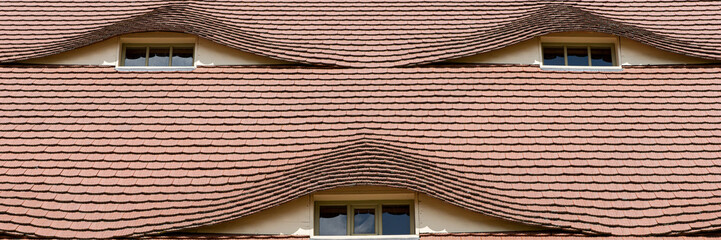 Semi-circular windows in the roof in a country cottage