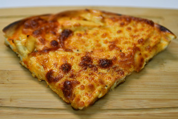 Slice of pizza Margherita on a wooden board