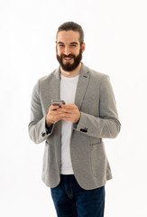 Portrait of a young happy attractive entrepreneur man checking emails and texting on mobile phone