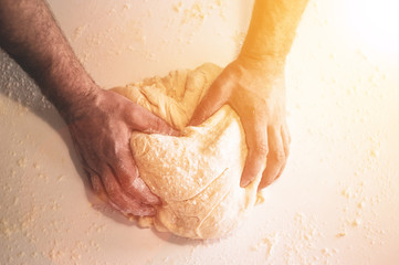 Classic wooden rolling pin with freshly prepared dough and dusting of flour on white background