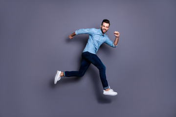 Fototapeta na wymiar Full length body size view portrait of his he nice cool perfect strong content cheerful cheery macho guy running activity marathon isolated over gray violet purple pastel background
